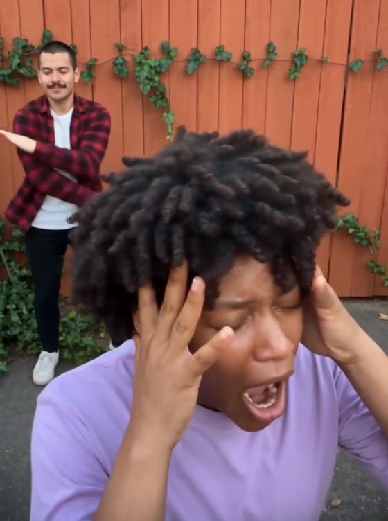 The Smalltown Boy dance clip: a woman in a lavender T-shirt screams into the camera while a man in plaid dances behind